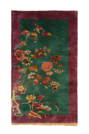 Antique Chinese decorative rug, 81x48 inches, featuring magenta and green hues with intricate floral and geometric patterns.